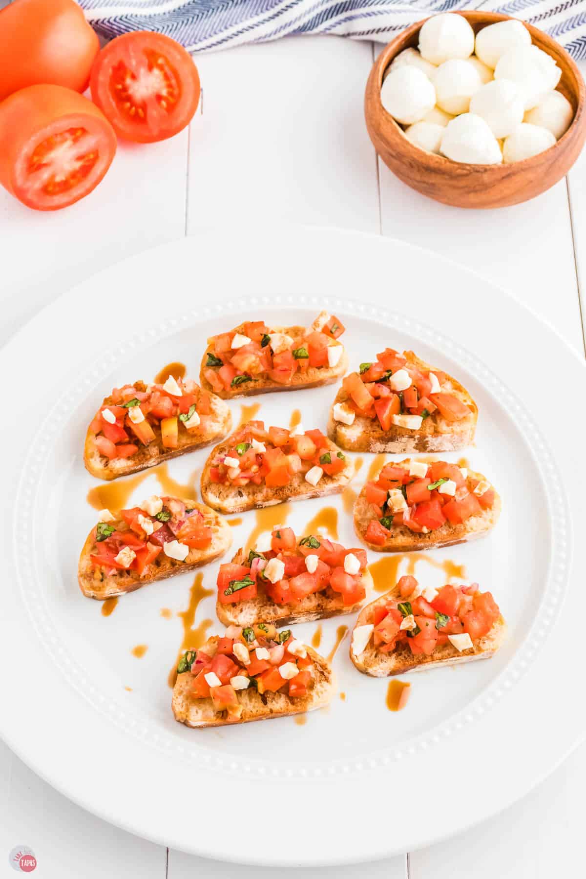 white plate with slices of tomatoes and bread
