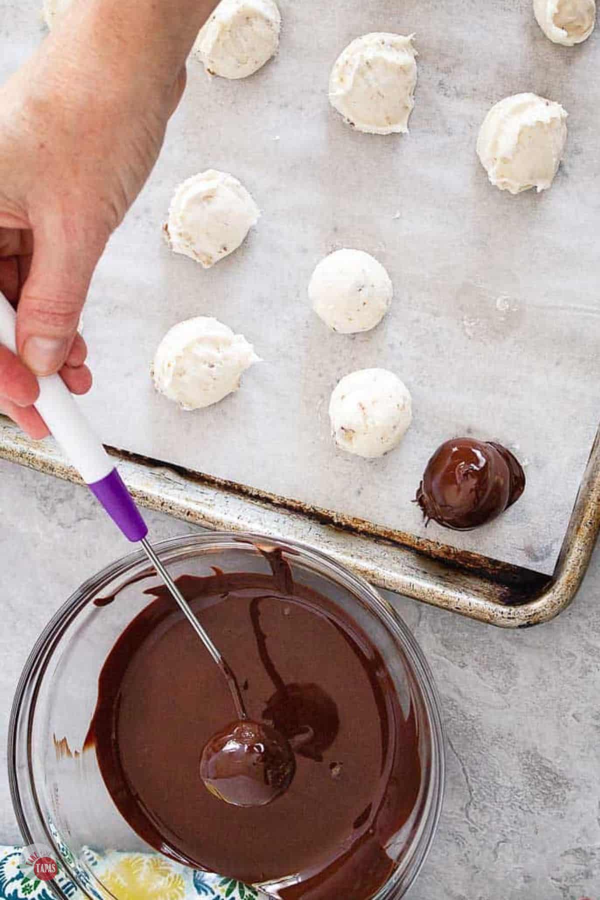 bourbon balls being dipped in chocolate